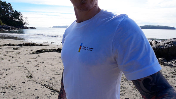 A close-up of a man wearing a Fault Line t-shirt