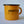 Load image into Gallery viewer, A side view of Fault Line&#39;s yellow enamel mug. The mug has a black lip. The front of the mug has a black Fault line logo on it.
